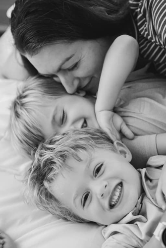 A Family cuddled in a bed