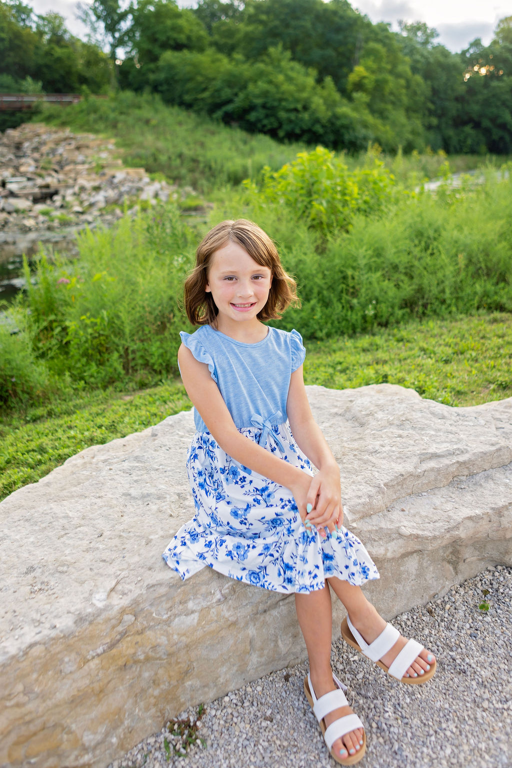 Young girl sitting in a Columbus Metro Park during a family portrait session